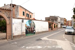 figura maschile e figura femminile ai lati di un carro trainato da buoi