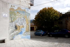 paesaggio agreste con alberi, fiume e animali